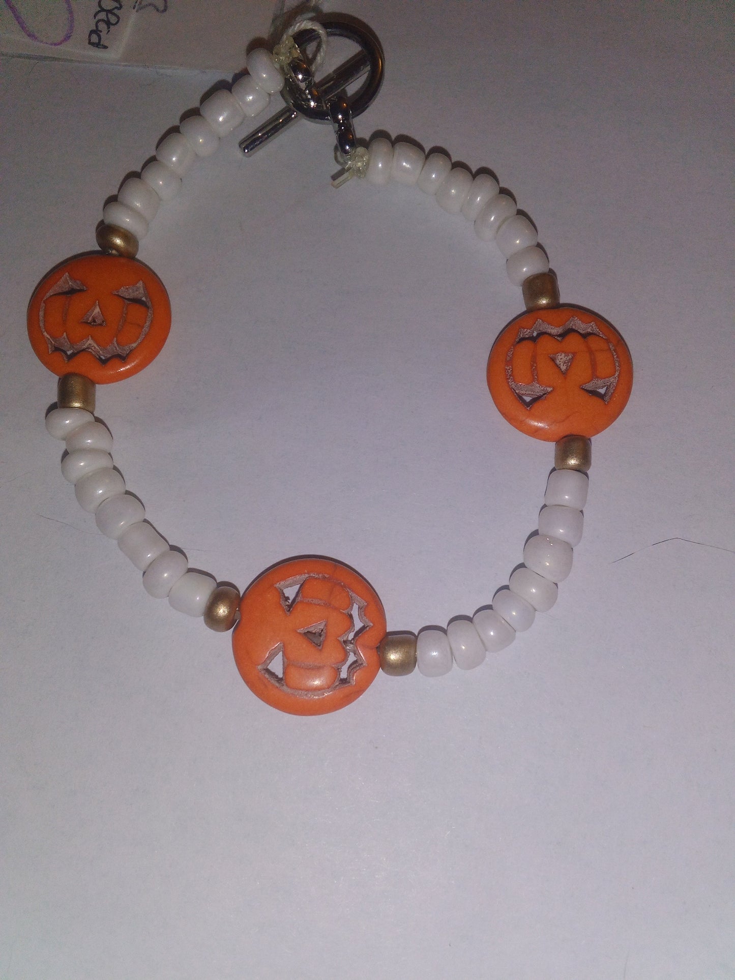 White beads with orange pumpkins
