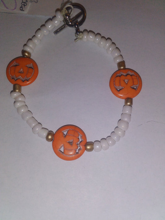 White beads with orange pumpkins