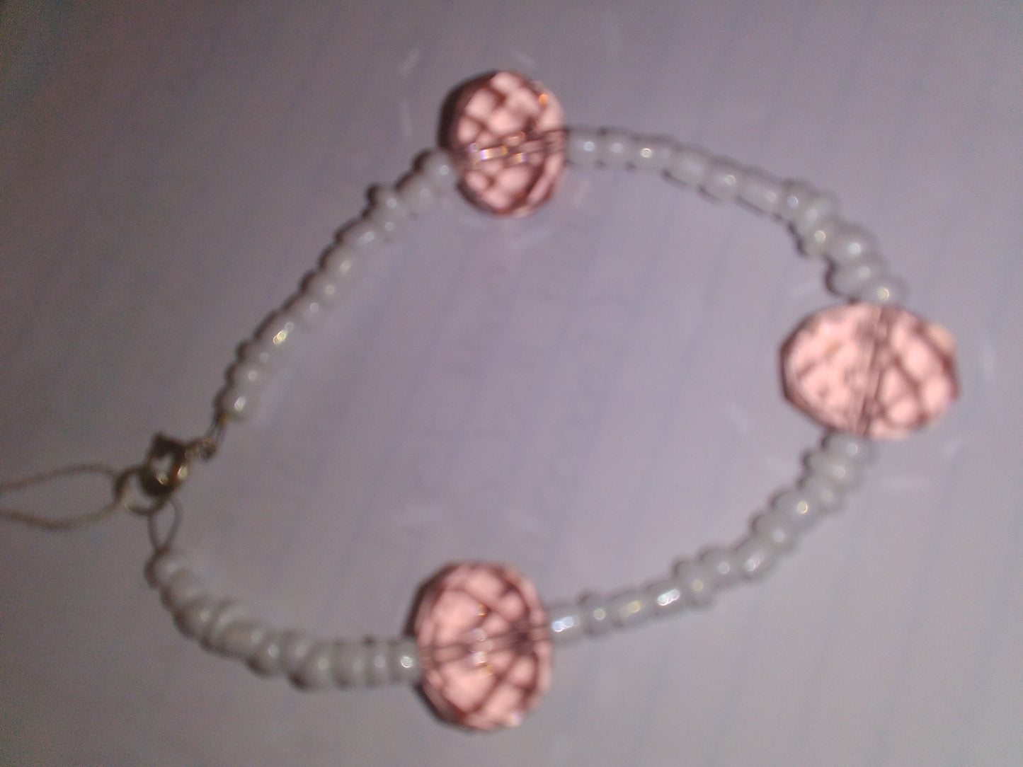 White seed beads with light pink crystal bead