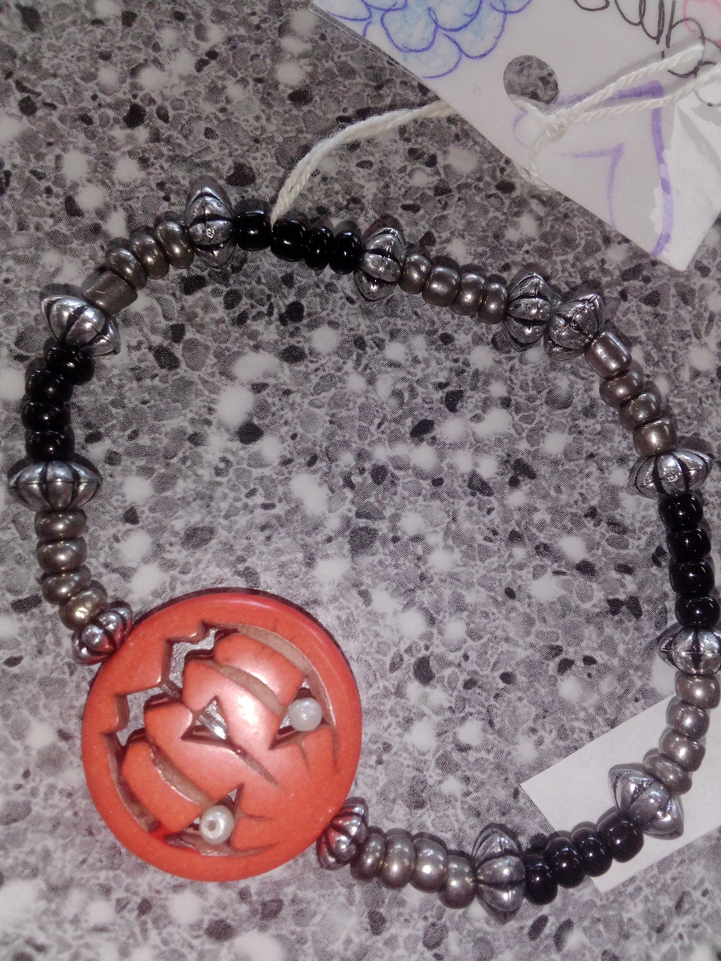 Dark gray seed beads black seed bead with sliver spacers with orange pumpkin