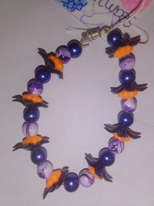 Blue pearl beads with purple black drizzle line with orange black flower