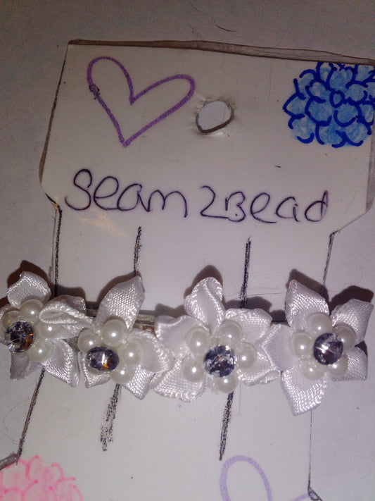 White flowers with white beads and metal gem