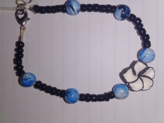 Black seed beads/blue drizzle back line with white flower