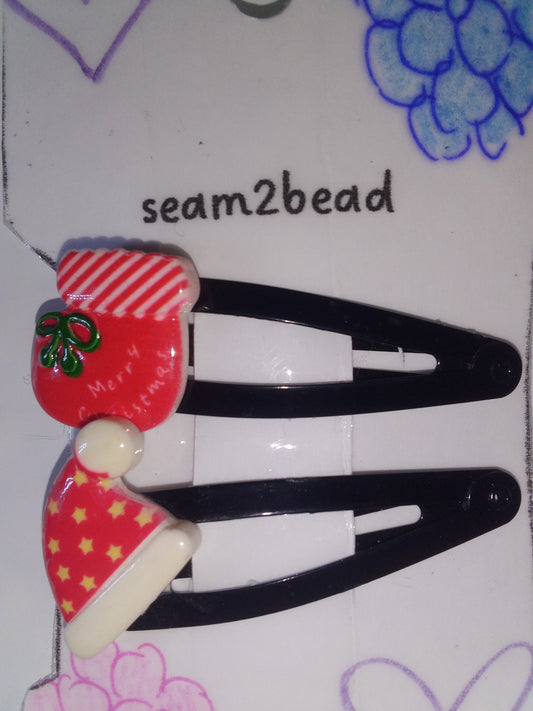 Red Santa hat with yellow stars and red stocking with green bow