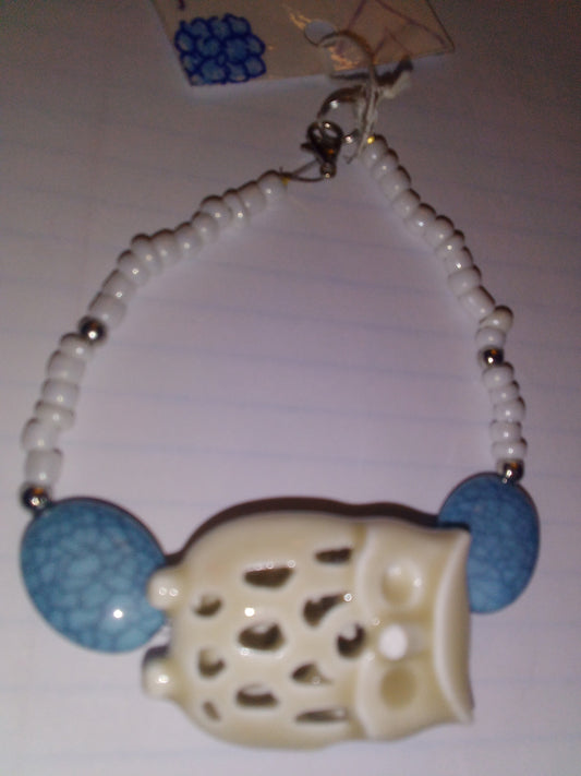 White seed beads sliver spacer with light blue crack oval beads with an glass owl
