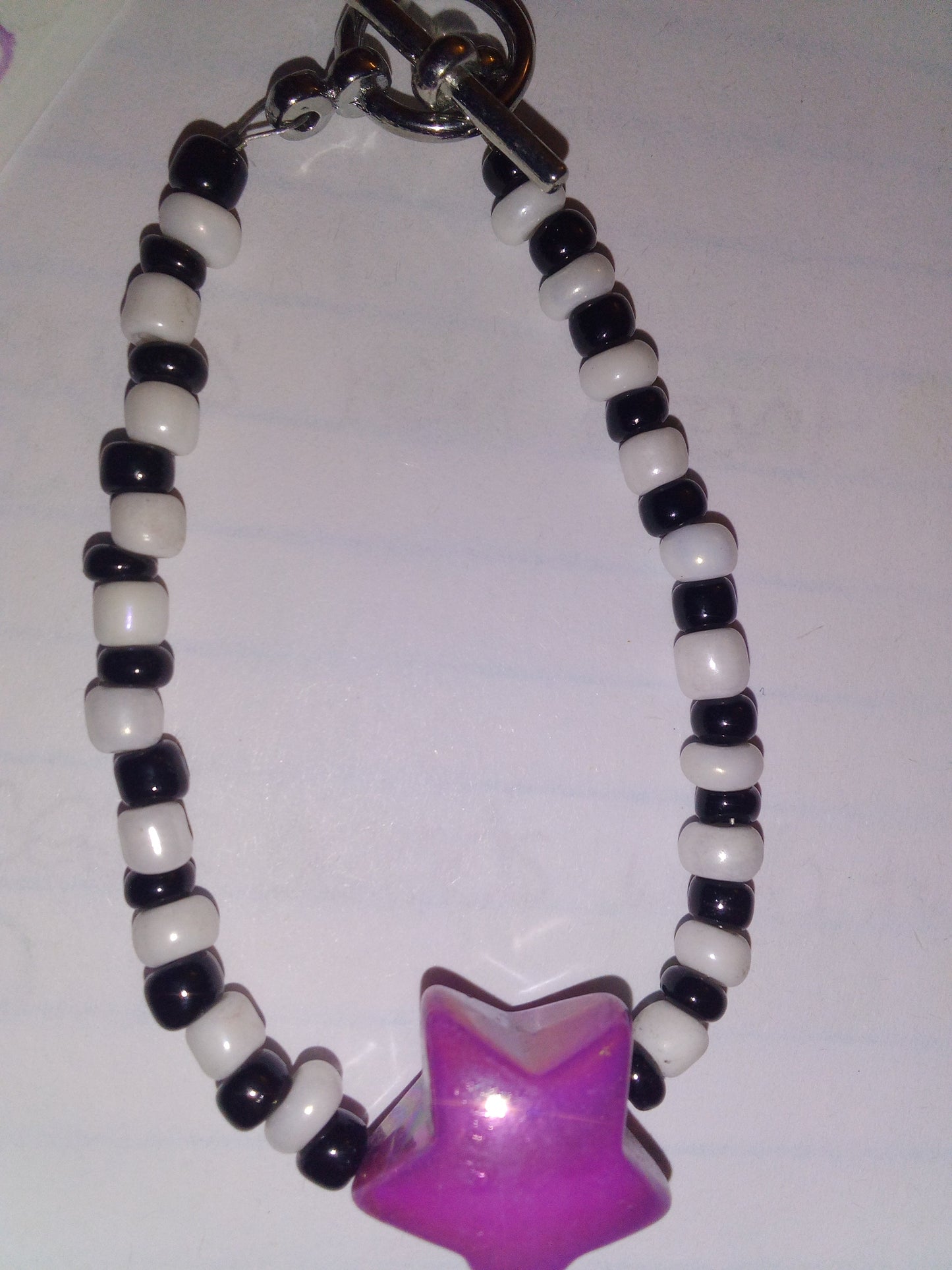 White/black seed beads with purple metallic star