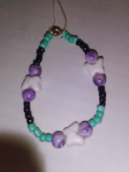 Teal green/black seed beads with purple black drizzle line with white butterfly